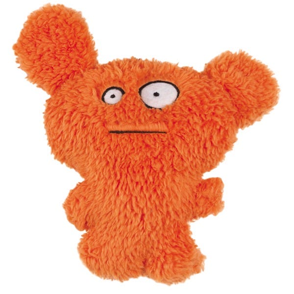 Orange plush dog toy with large ears and a mischievous face.