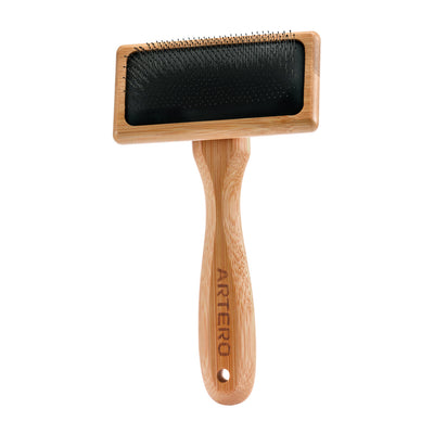 Artero bamboo slicker brush with black pins and air cushion system.