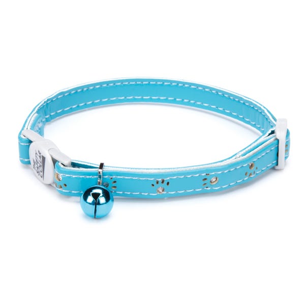 Blue cat collar with silver paw prints and a silver bell.